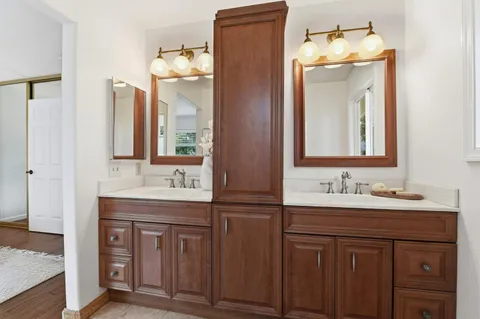 a bathroom with a double vanity sink and a mirror