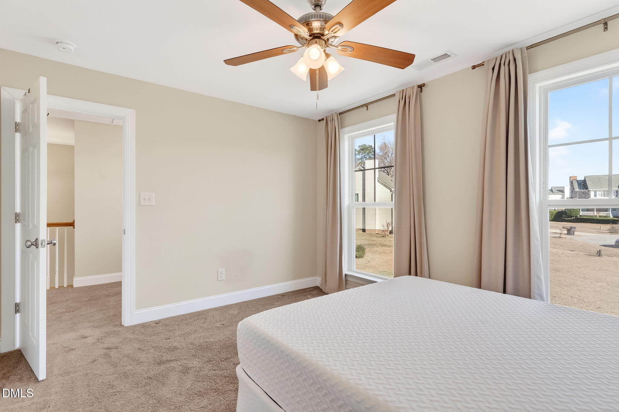27 Duchess Court Angier, NC 27501 - Photo 24 of 50 a bedroom with a large bed and a chandelier
