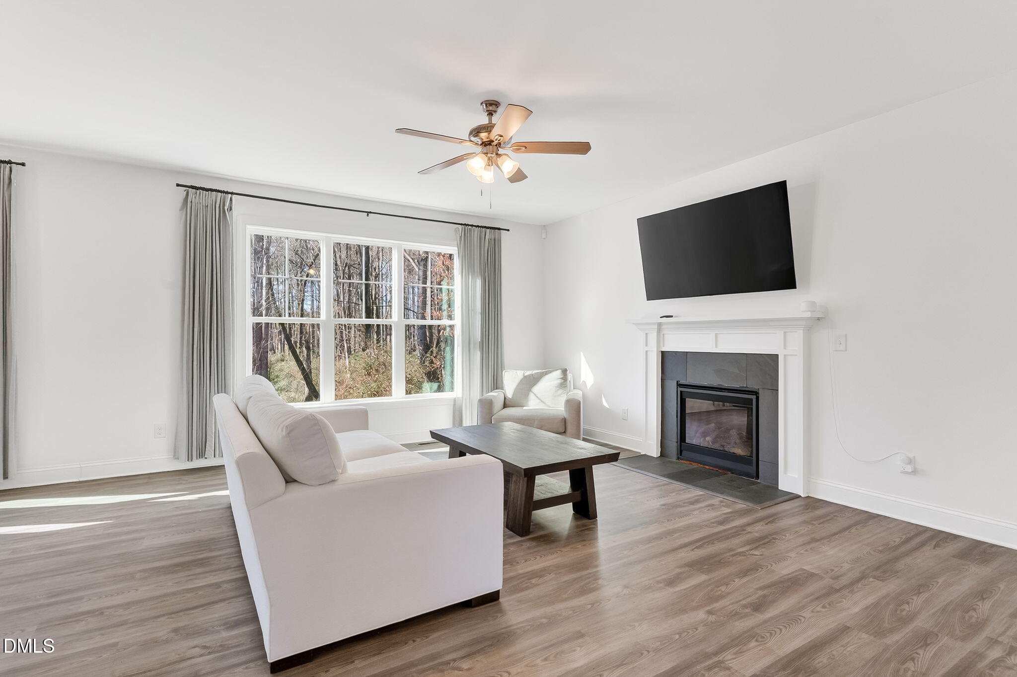 27 Duchess Court Angier, NC 27501 - Photo 6 of 50 a living room with furniture a fireplace and a flat screen tv