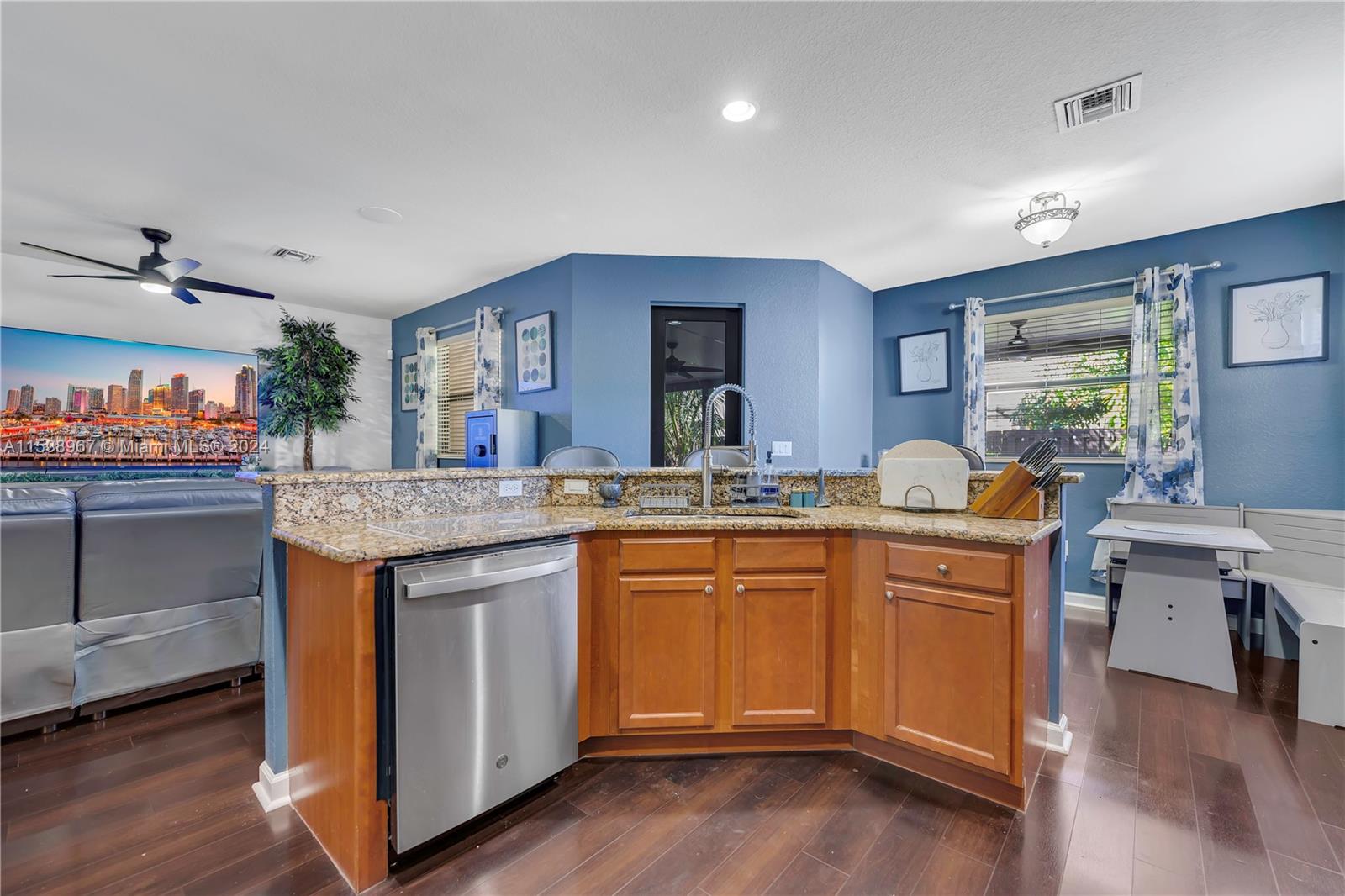24084 Southwest 113th Path Homestead, FL 33032 - Photo 11 of 37 a kitchen with granite countertop sink stove and wooden floor