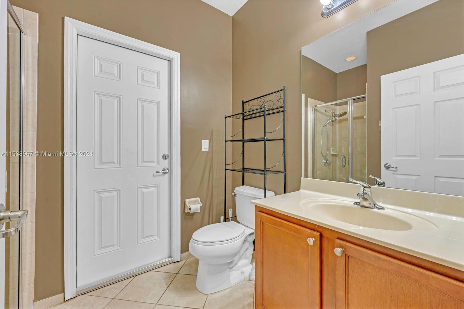 24084 Southwest 113th Path Homestead, FL 33032 - Photo 14 of 37 a bathroom with a sink a toilet and shower