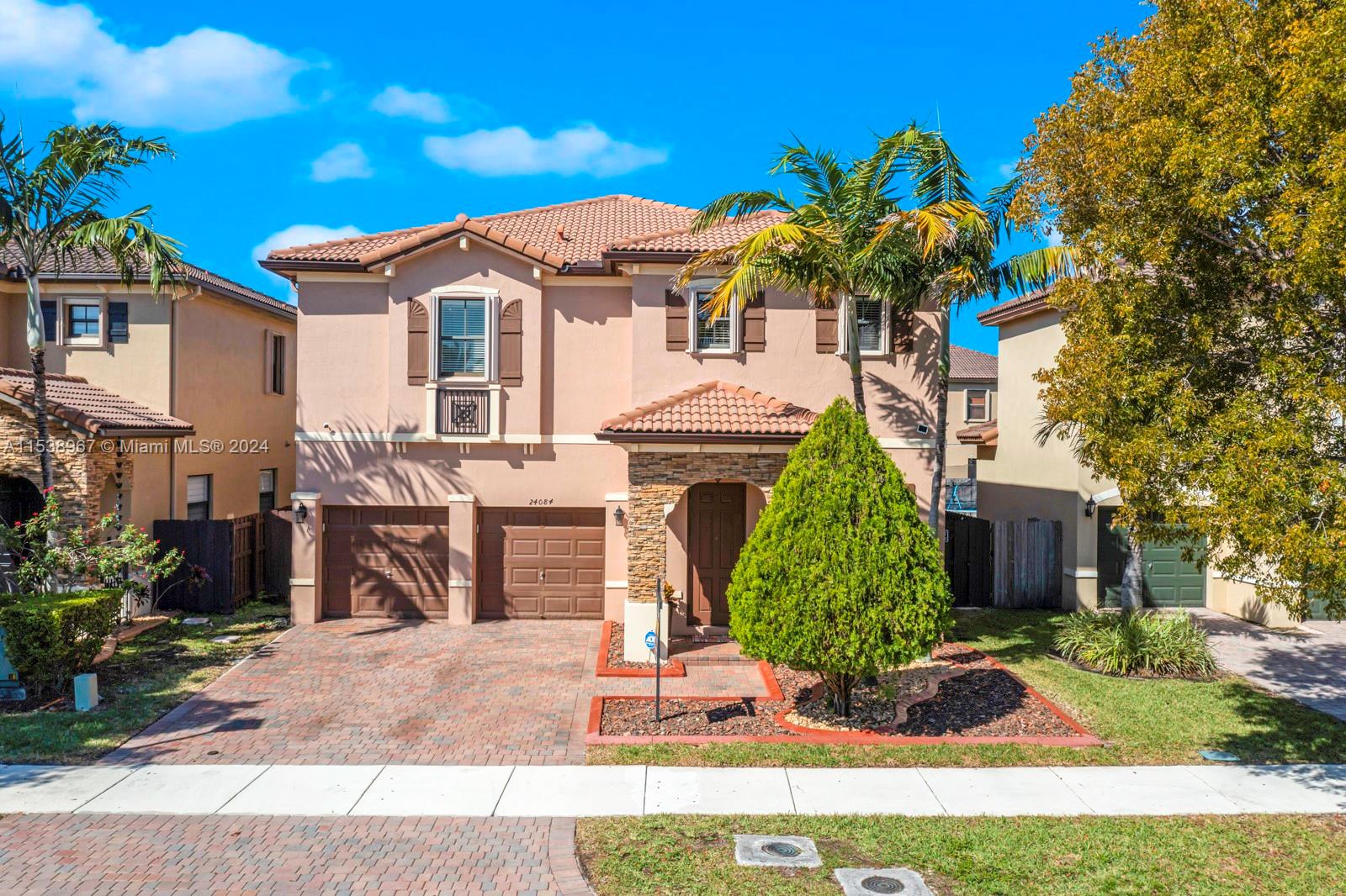 24084 Southwest 113th Path Homestead, FL 33032 - Photo 2 of 37 a front view of a house with a yard