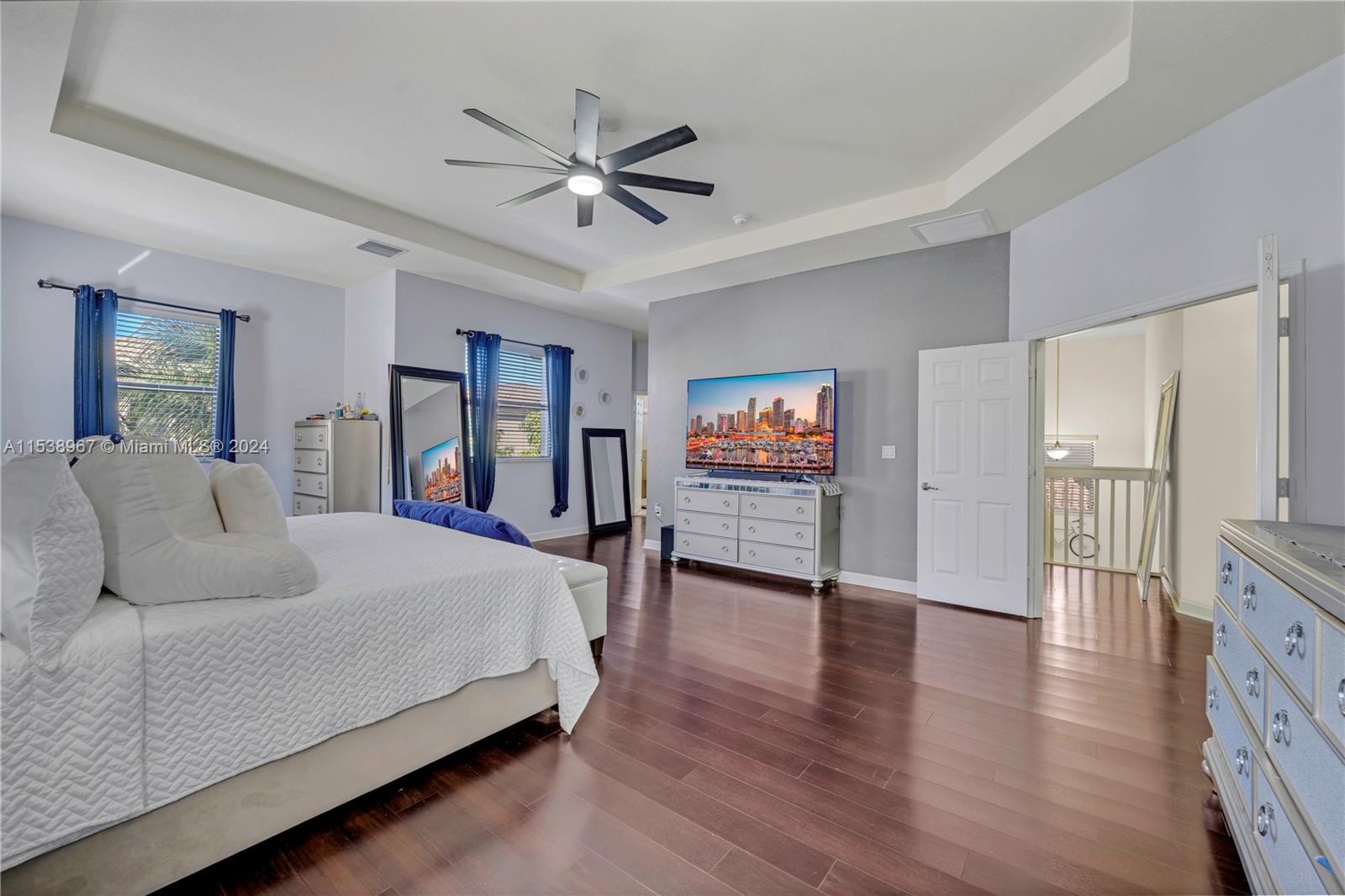 24084 Southwest 113th Path Homestead, FL 33032 - Photo 23 of 37 a bedroom with a bed and a chandelier