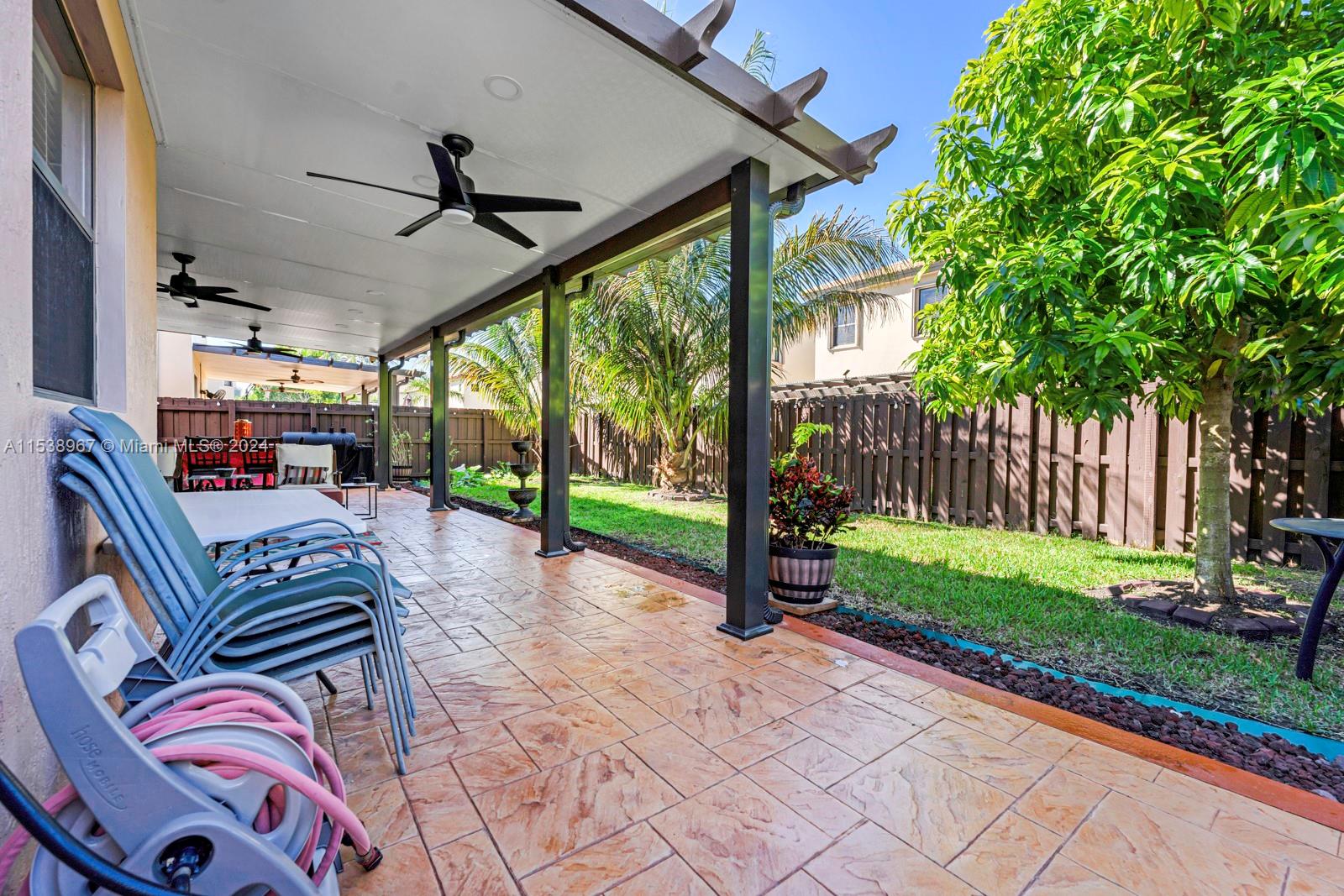 24084 Southwest 113th Path Homestead, FL 33032 - Photo 28 of 37 a view of a porch with furniture and garden