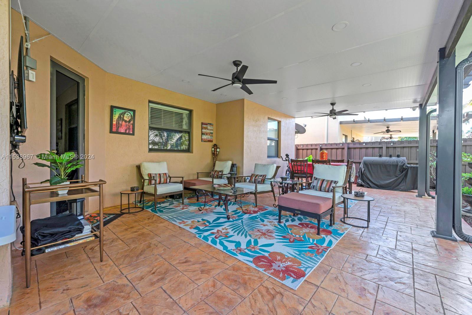 24084 Southwest 113th Path Homestead, FL 33032 - Photo 29 of 37 a living room with furniture a dining table and a potted plant