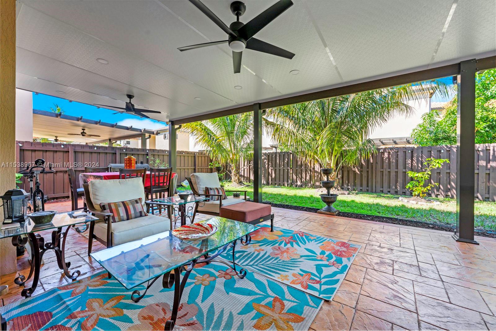 24084 Southwest 113th Path Homestead, FL 33032 - Photo 30 of 37 a living room with patio furniture and a floor to ceiling window