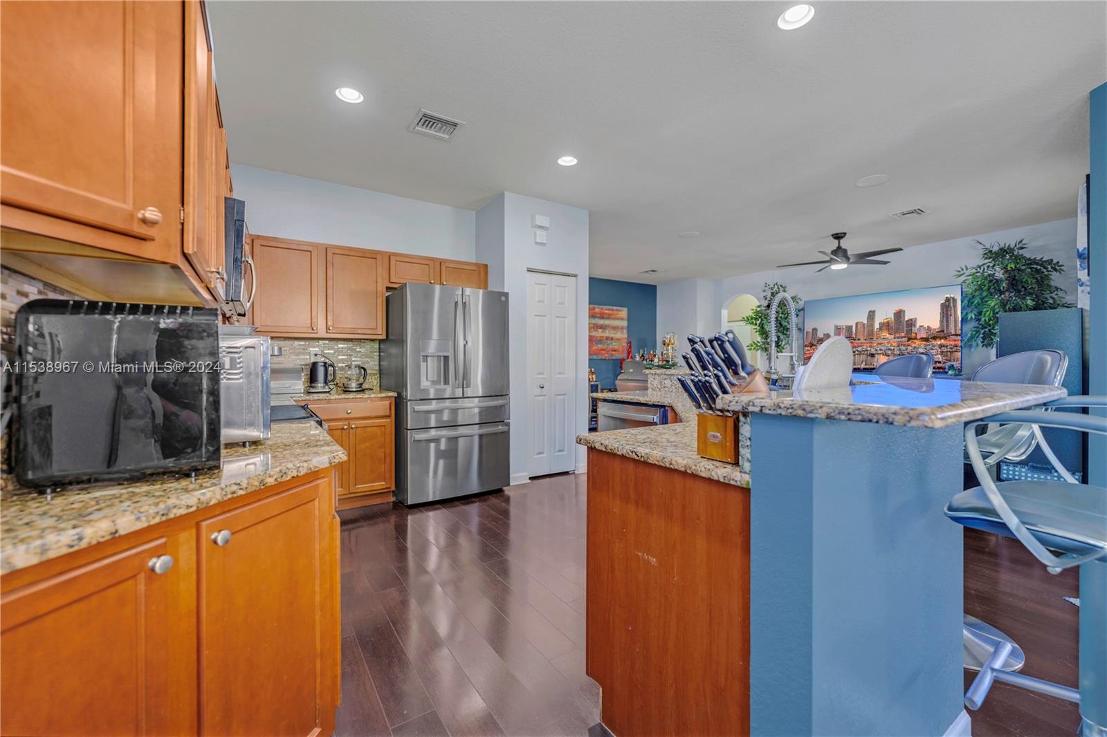 24084 Southwest 113th Path Homestead, FL 33032 - Photo 9 of 37 a kitchen with stainless steel appliances granite countertop a refrigerator a stove and a wooden floors