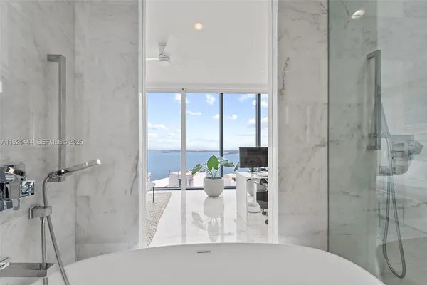 a dining room with furniture and a floor to ceiling window