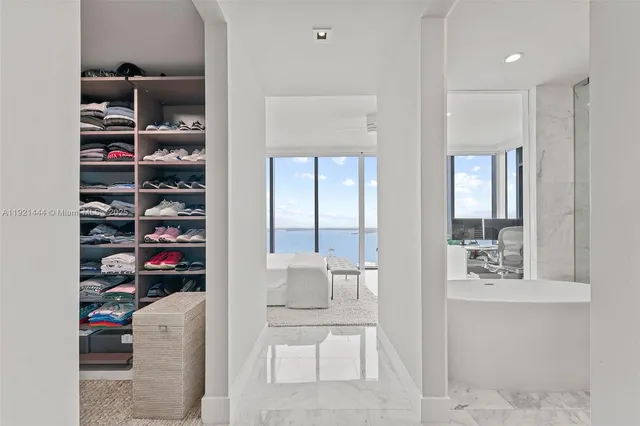 a living room with a bed and a table with potted plants