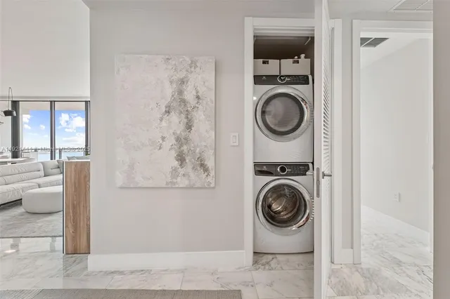 a bedroom with a bed and large windows