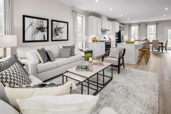 a living room with furniture and kitchen view