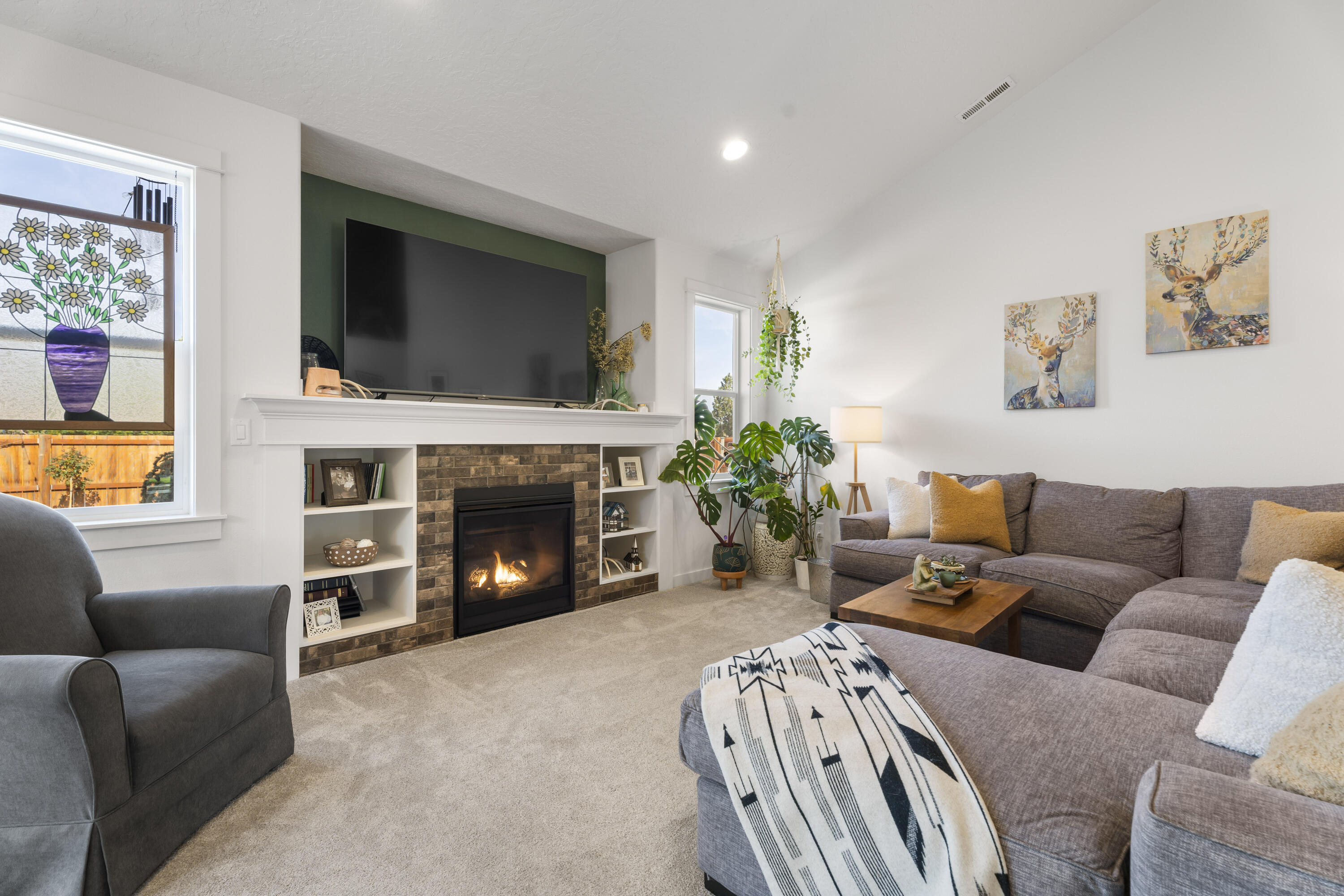 21030 Yeoman Road Bend, OR 97701 - Photo 7 of 66 a living room with furniture a flat screen tv and a fireplace
