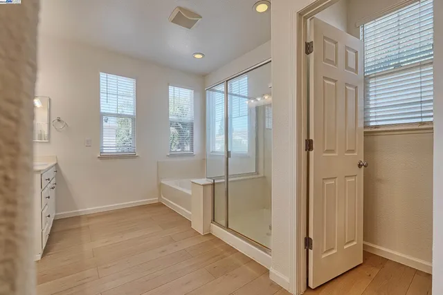 a view of an empty room with window and hallway