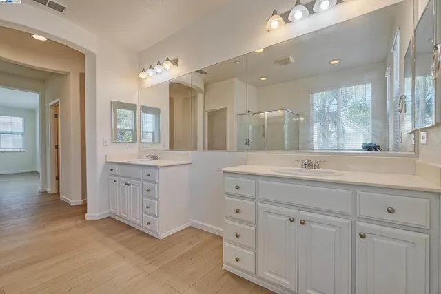 a bathroom with a double vanity sink and a mirror