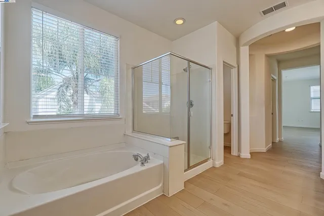 a bathroom with a bathtub and a shower