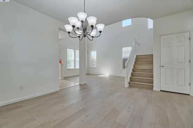 a view of a chandelier in a room with wooden floor