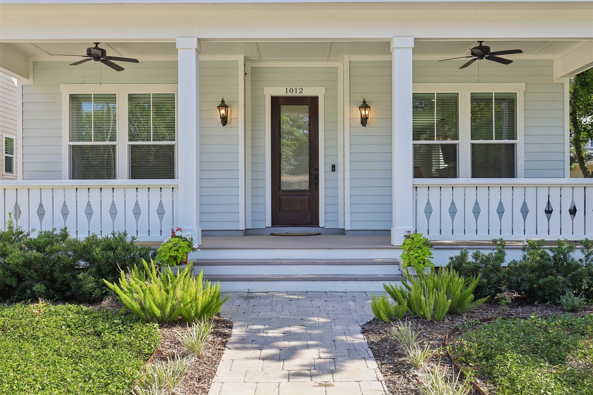 1012 White Street Fernandina Beach, FL 32034 - Photo 2 of 35 a front view of a house with potted plants and wooden fence