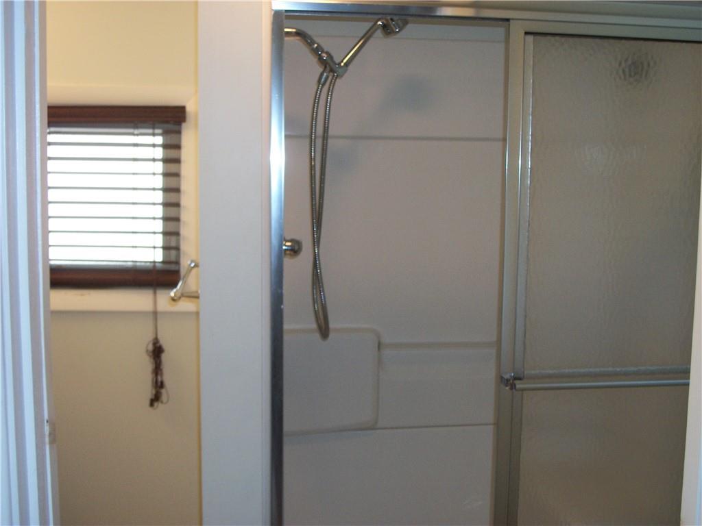 101 Carmichaels Street Rices Landing, PA 15357 - Photo 19 of 28 a bathroom with a glass shower door