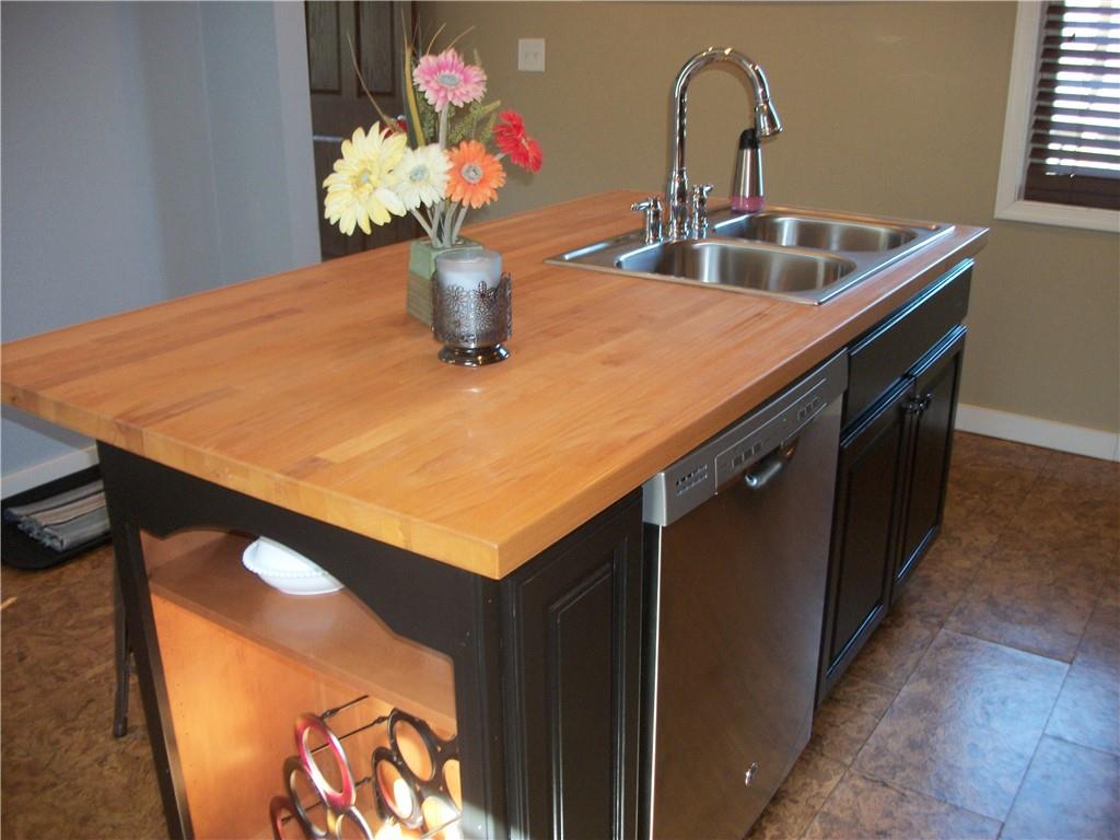101 Carmichaels Street Rices Landing, PA 15357 - Photo 9 of 28 a kitchen with a sink cabinets and wooden floor