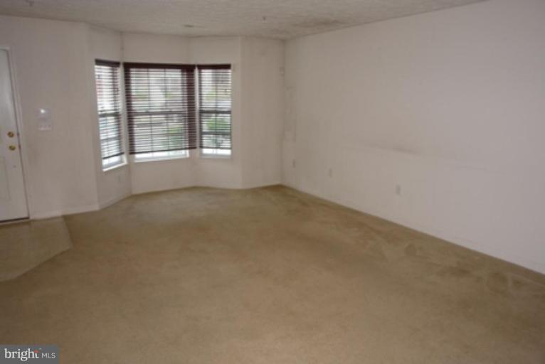 1604 Briarview Court, Unit 64 Severn, MD 21144 - Photo 2 of 10 an empty room with windows