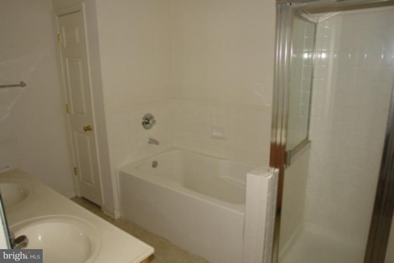 1604 Briarview Court, Unit 64 Severn, MD 21144 - Photo 10 of 10 a bathroom with a bathtub and a toilet
