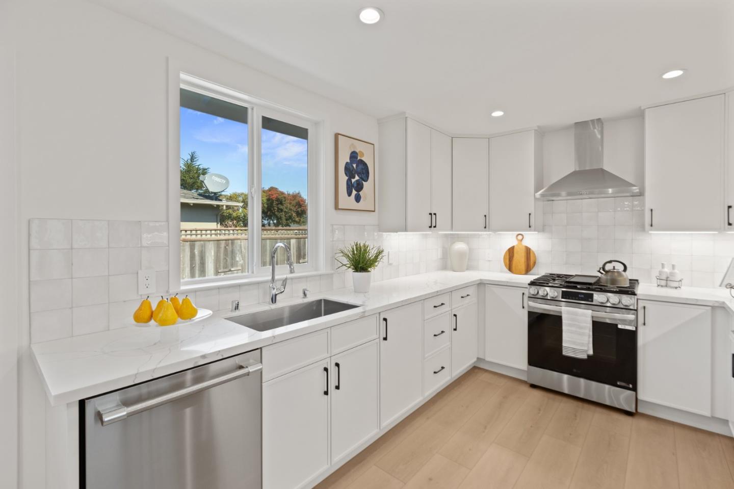 1384 Solano Drive Pacifica, CA 94044 - Photo 14 of 45 a kitchen with a sink and white cabinets