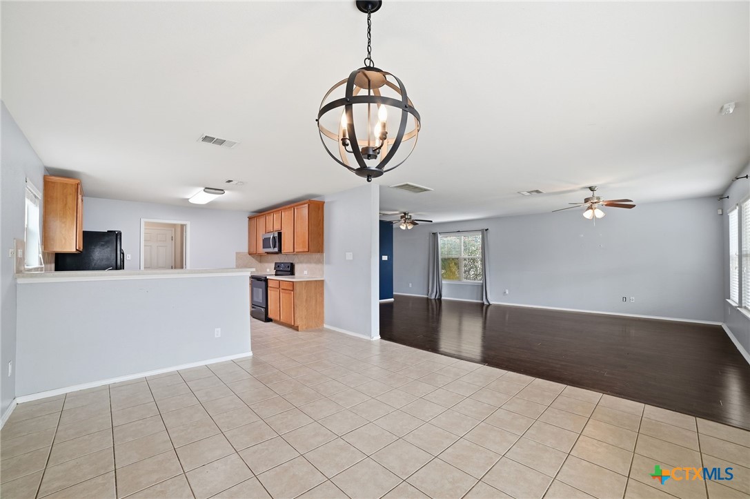 316 Housefinch Loop Leander, TX 78641 - Photo 12 of 37 Dining area with updated lighting and easy access to backyard.