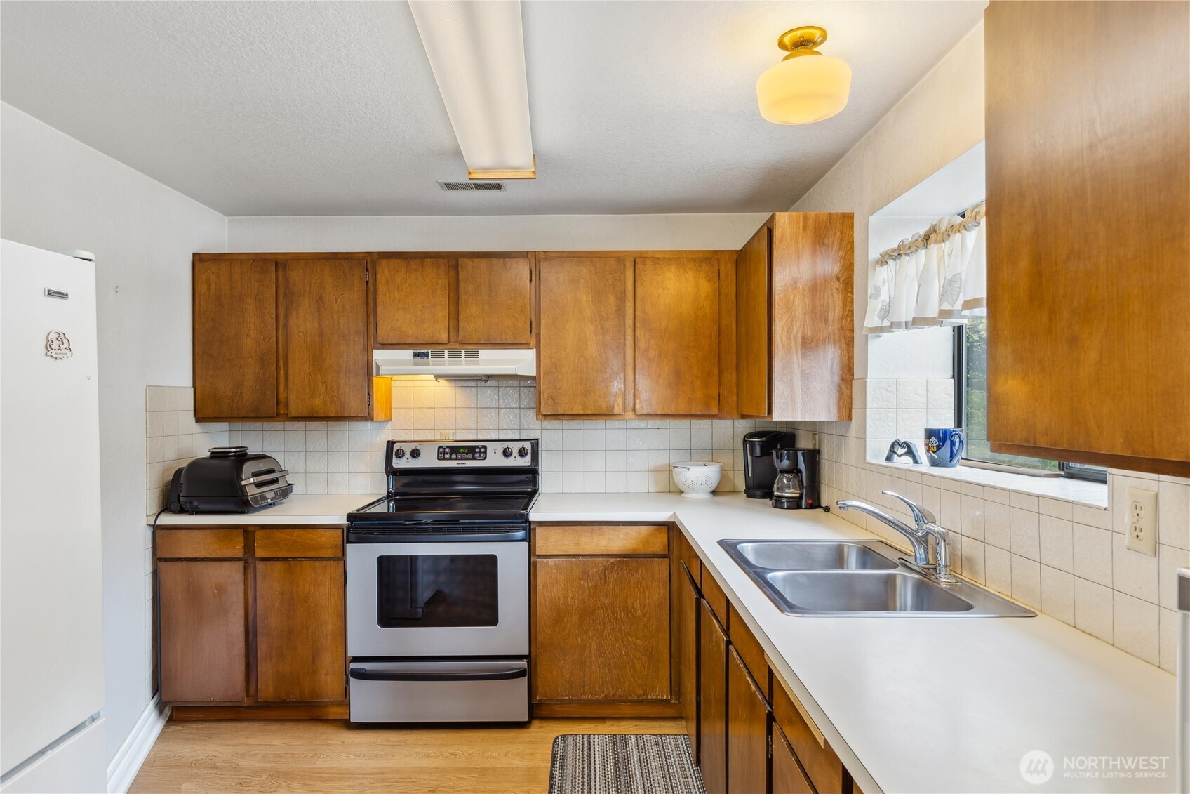 4314 Bryce Drive Anacortes, WA 98221 - Photo 23 of 40 a kitchen with a stove a sink and a microwave