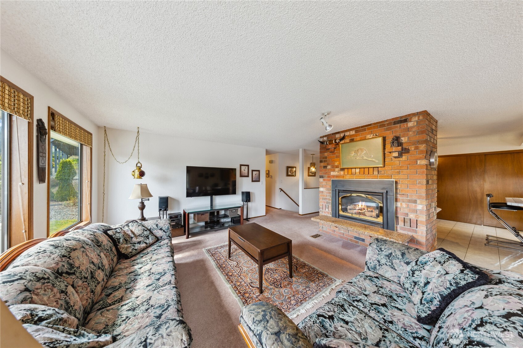 4314 Bryce Drive Anacortes, WA 98221 - Photo 5 of 40 a living room with furniture a fireplace and a flat screen tv
