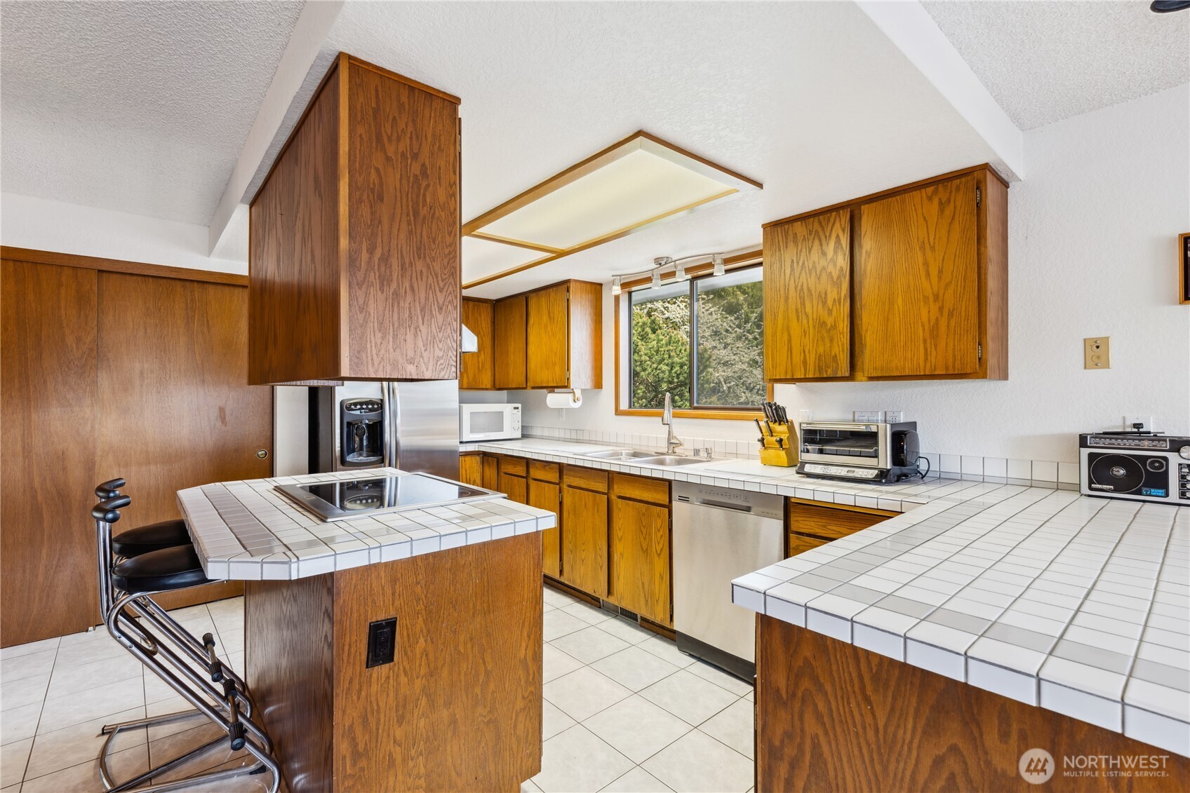 4314 Bryce Drive Anacortes, WA 98221 - Photo 8 of 40 a kitchen with stainless steel appliances granite countertop a sink stove and refrigerator