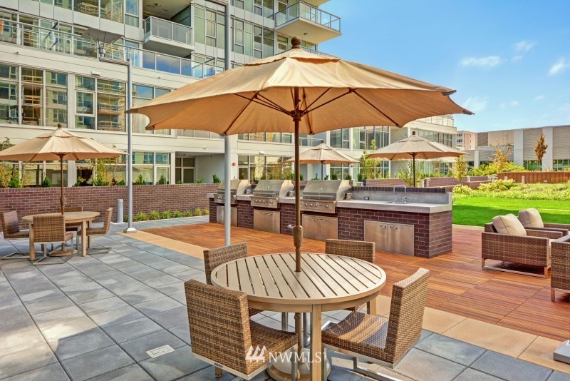 588 Bell Street, Unit 814S Seattle, WA 98121 - Photo 18 of 37 a patio with a table and chairs under an umbrella