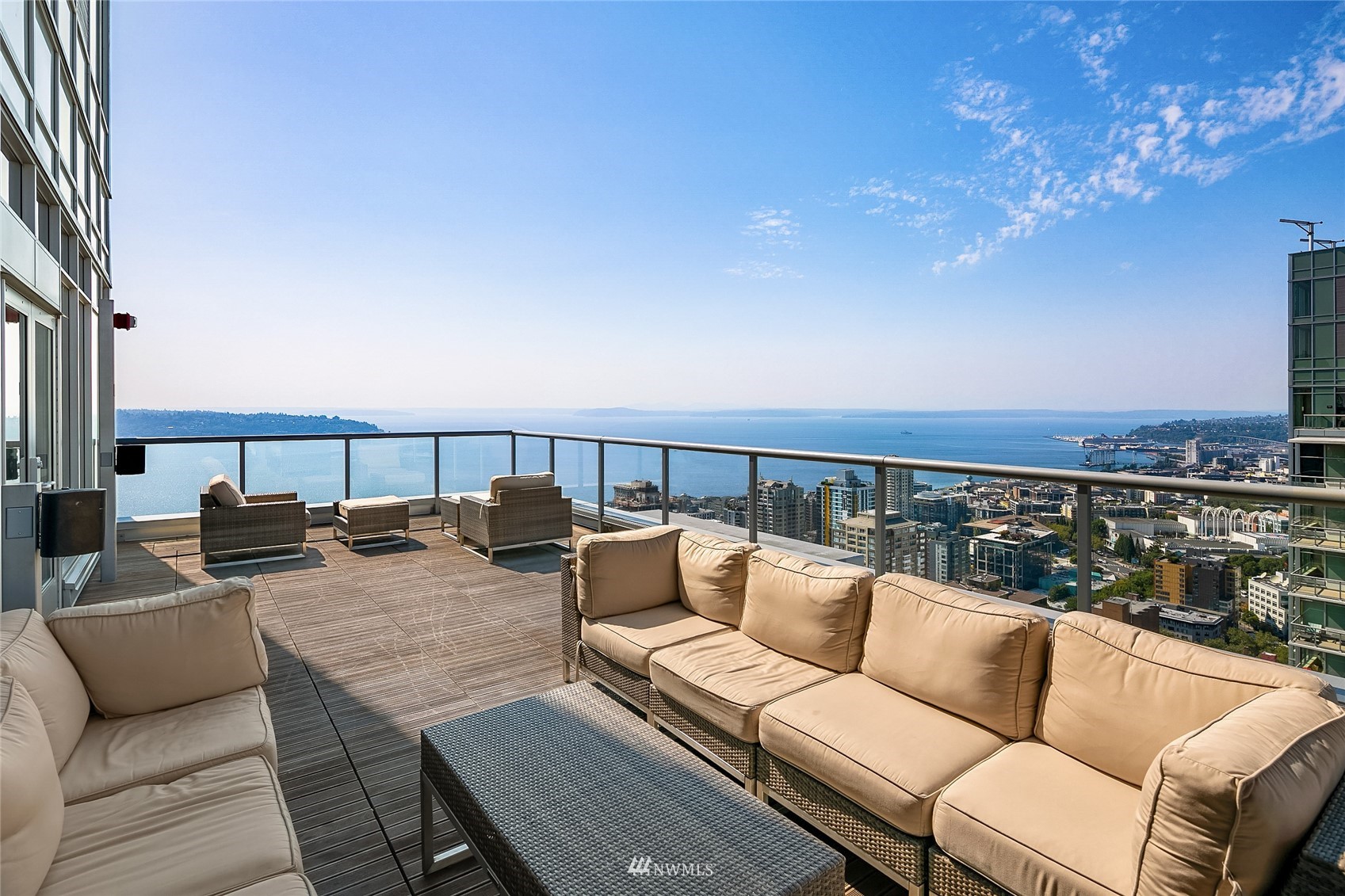 588 Bell Street, Unit 814S Seattle, WA 98121 - Photo 30 of 37 a roof deck with couches and potted plants with sky view