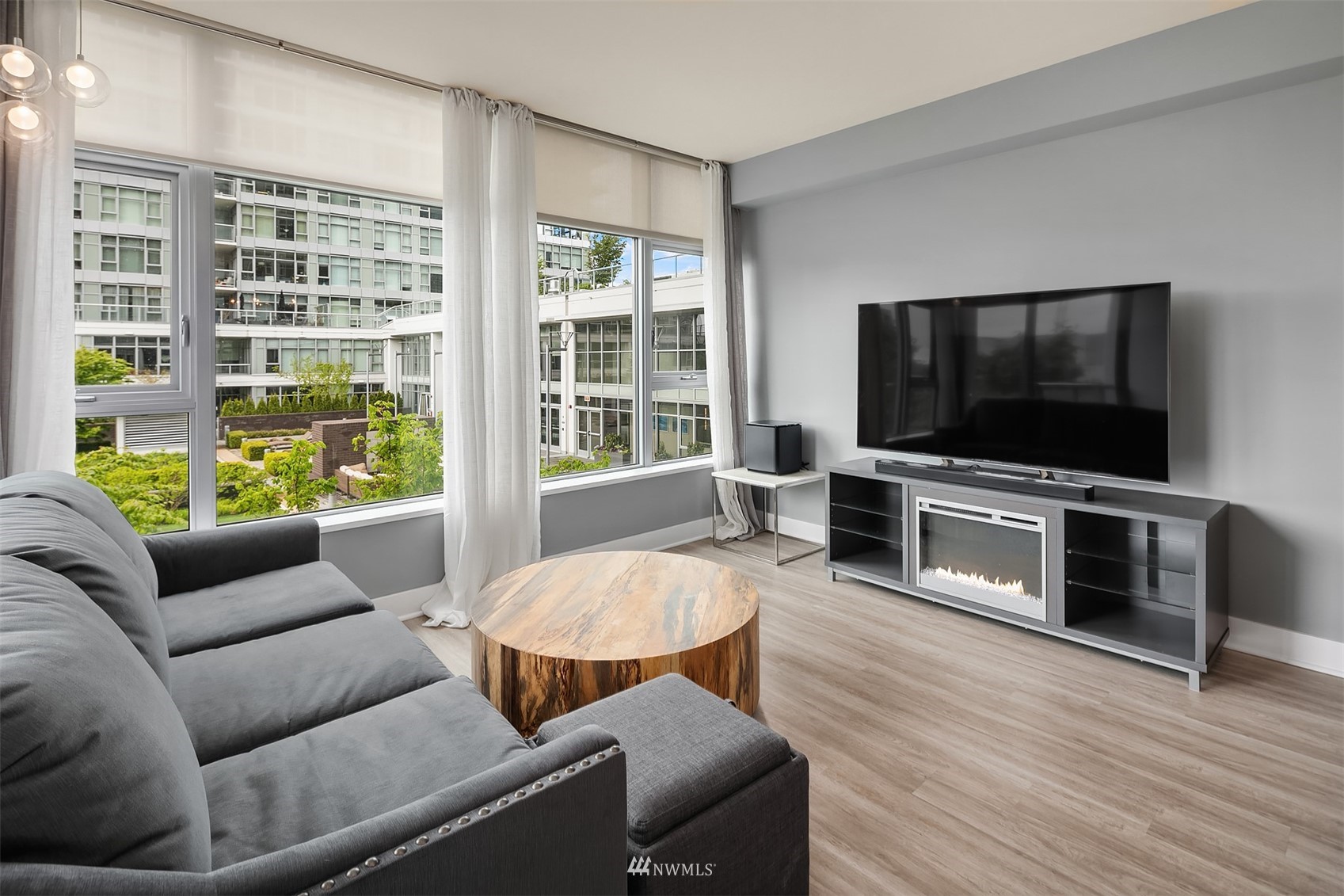588 Bell Street, Unit 814S Seattle, WA 98121 - Photo 6 of 37 a living room with furniture and a flat screen tv