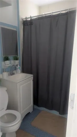 a bathroom with a toilet a sink and a mirror