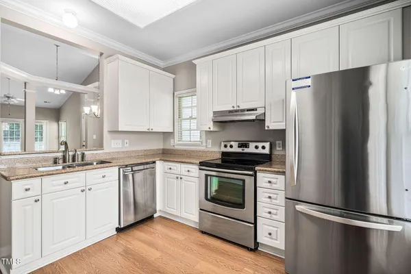 a kitchen with stainless steel appliances and wooden cabinets