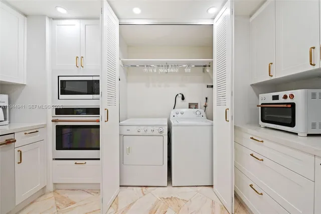 a kitchen with microwave stove and cabinets