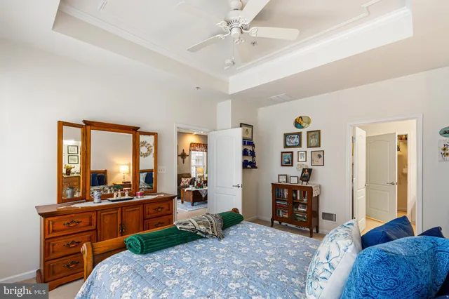 a bedroom with furniture and a large window