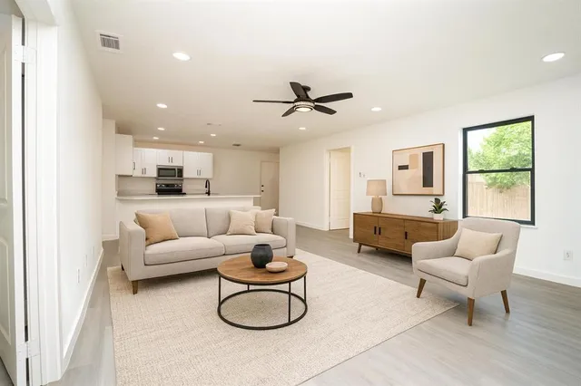 a living room with furniture and a large window