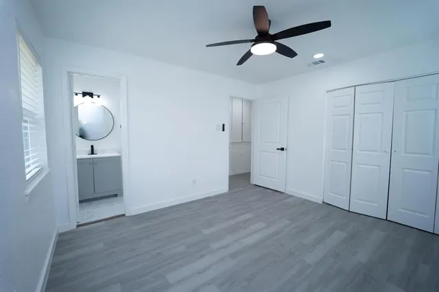 a bedroom with bed and wooden floor
