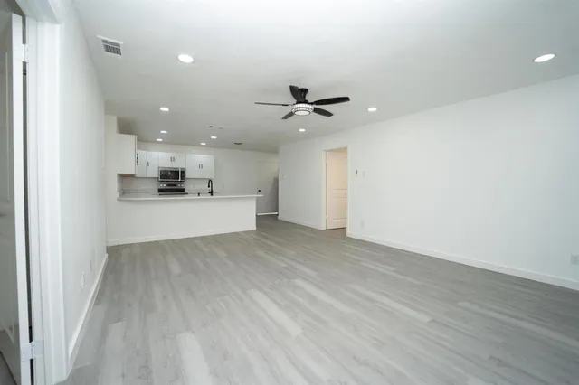 a view of a kitchen with a sink and wooden floor