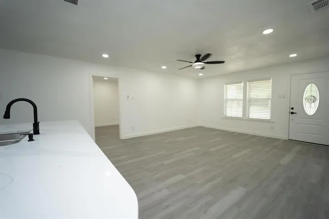 a view of a livingroom with a ceiling fan and window