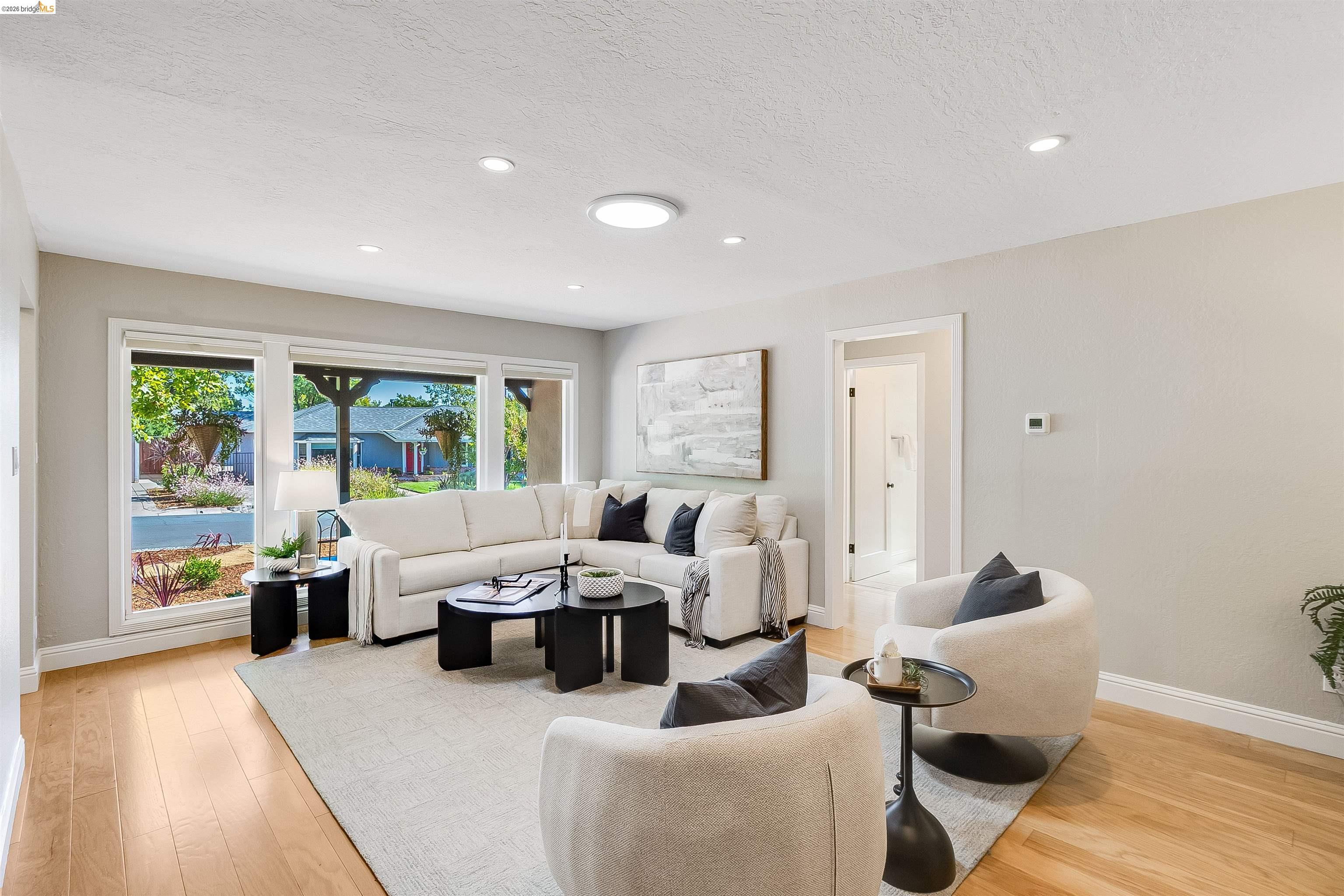 346 Valley View Road Pleasant Hill, CA 94523 - Photo 12 of 57 Spacious living area featuring large picture windows, wood-finish flooring, recessed lighting, and a neutral color palette