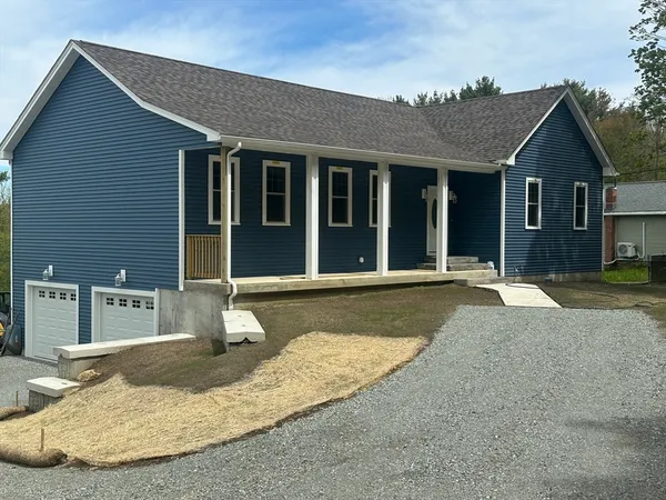 a view of a house with a backyard
