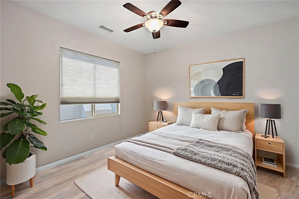 11362 Hutton Road Corona, CA 92883 - Photo 18 of 31 a bedroom with a bed and a potted plant