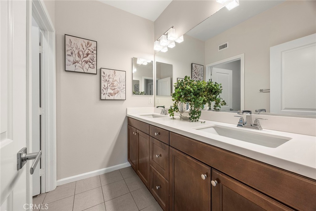 11362 Hutton Road Corona, CA 92883 - Photo 19 of 31 a spacious bathroom with a double vanity sink mirror and