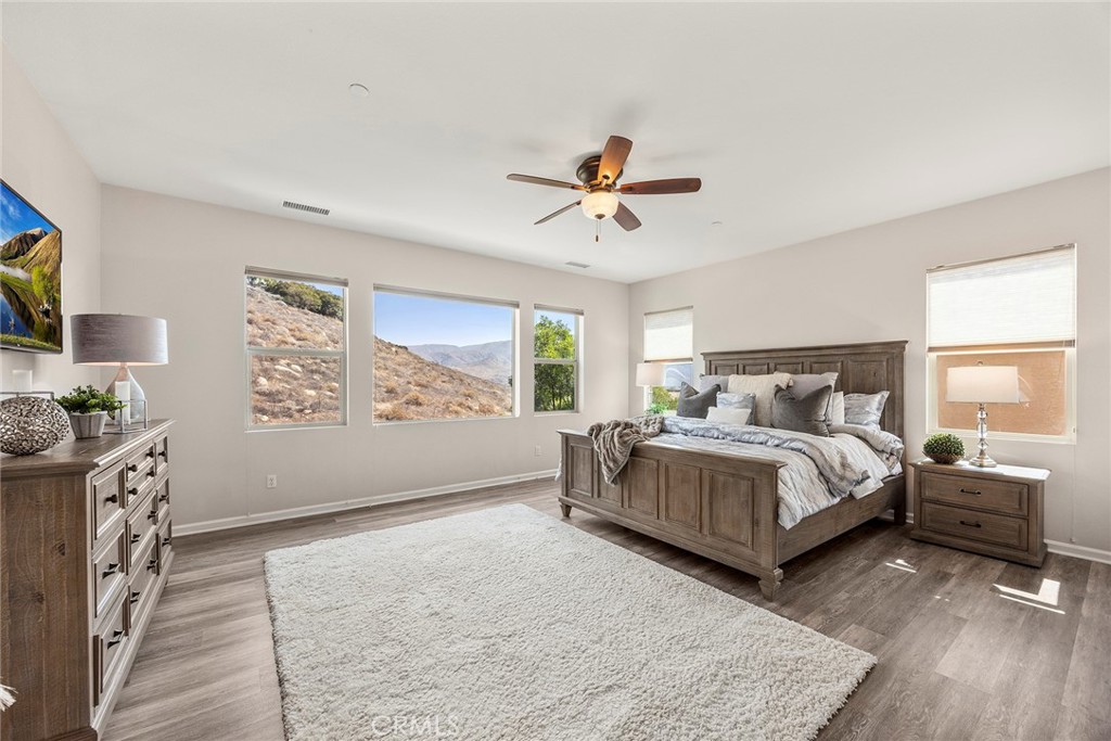 11362 Hutton Road Corona, CA 92883 - Photo 21 of 31 a spacious bedroom with a bed and a flat screen tv