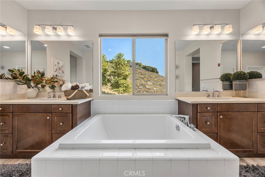11362 Hutton Road Corona, CA 92883 - Photo 24 of 31 a spacious bathroom with a tub sink and mirror