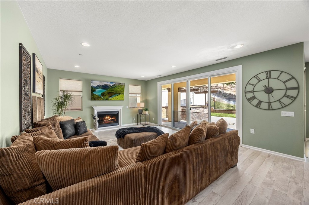 11362 Hutton Road Corona, CA 92883 - Photo 6 of 31 a living room with furniture large window and wooden floor