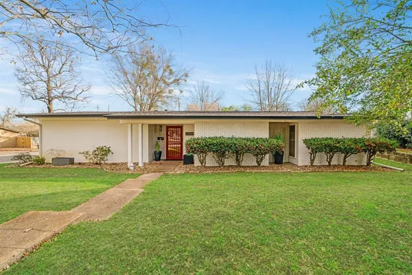 a view of a house with a yard and sitting area