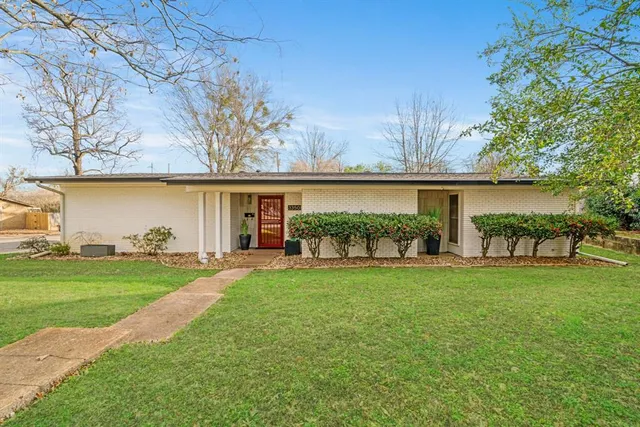a view of a house with a yard and sitting area